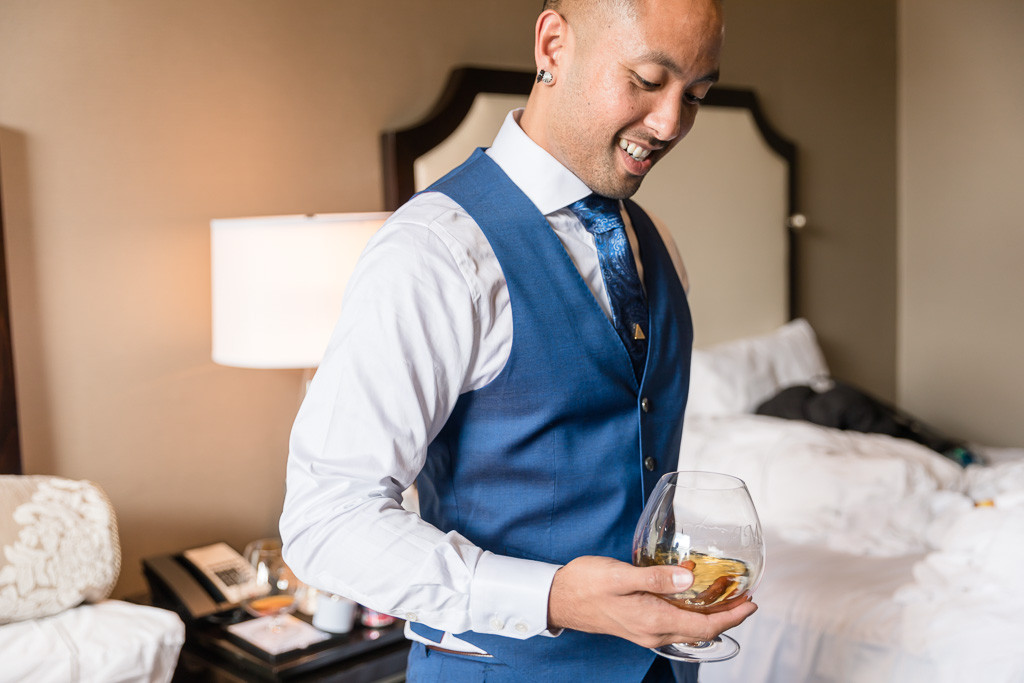 groom at the Fairmont with a glass of whiskey
