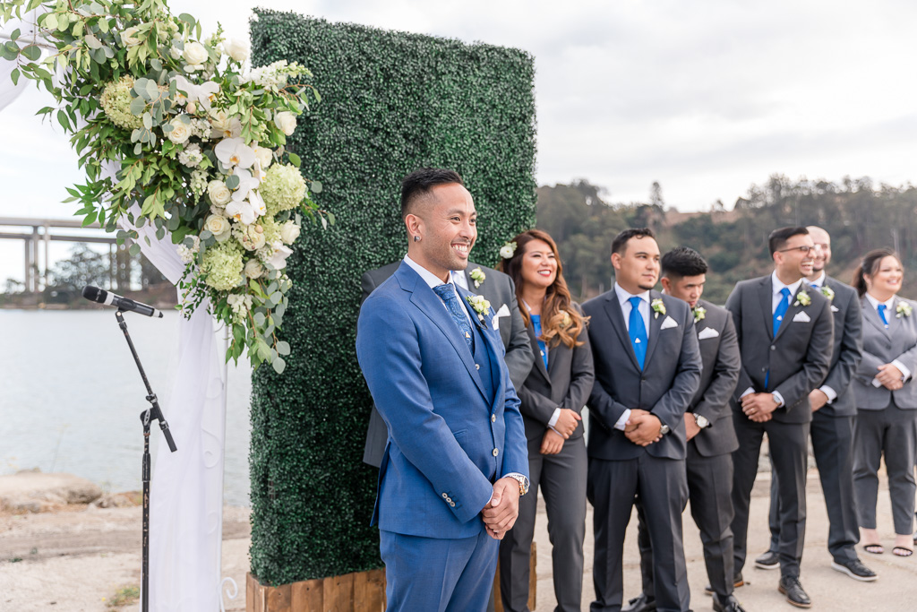 groom anxiously awaiting bride during wedding ceremony