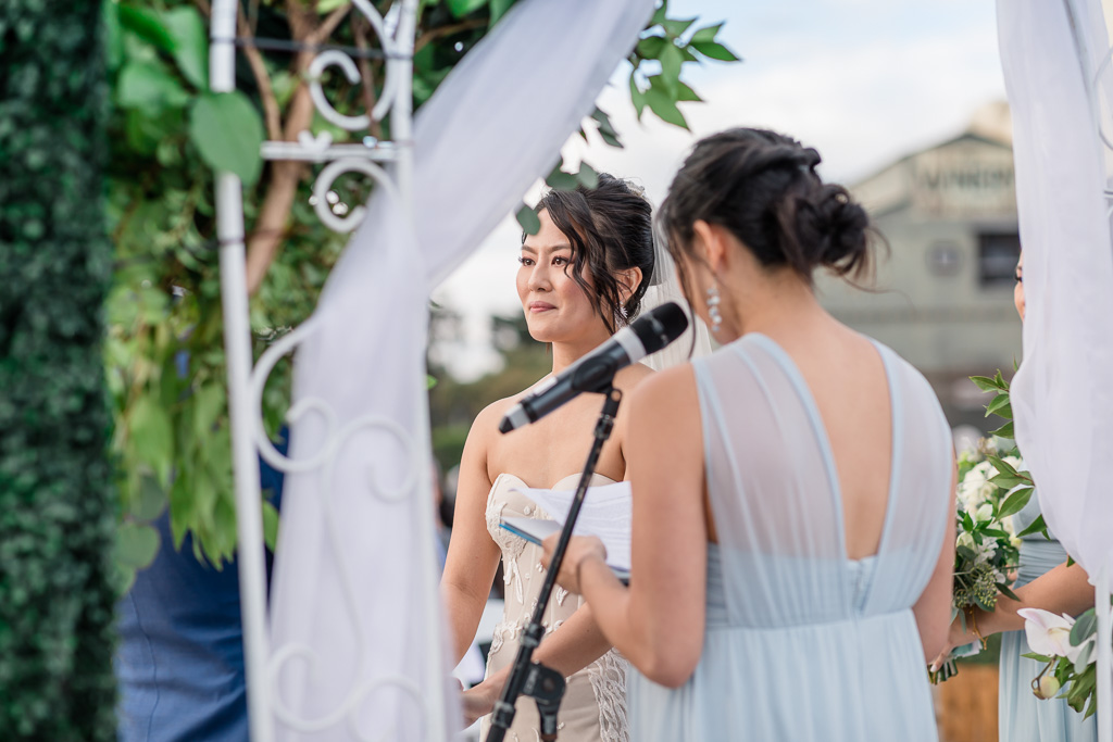 alternate angle of bride looking at her groom during ceremony