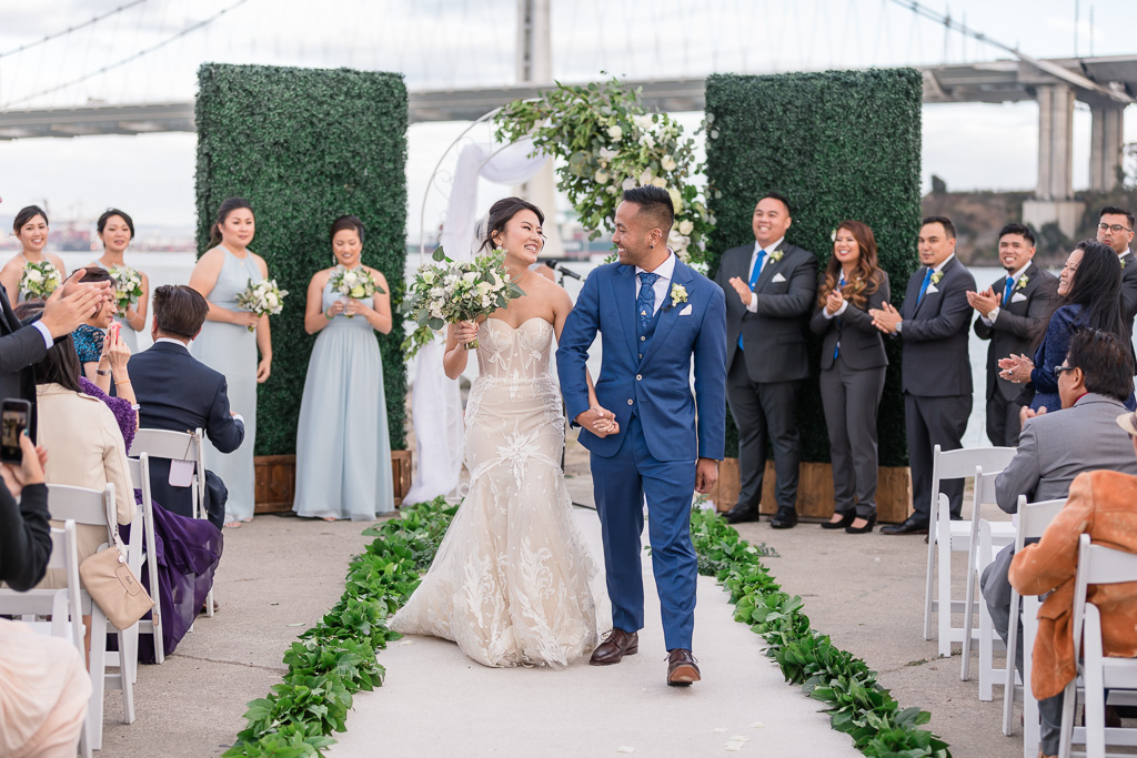 bride and groom ceremony recessional with the Bay Bridge in the background