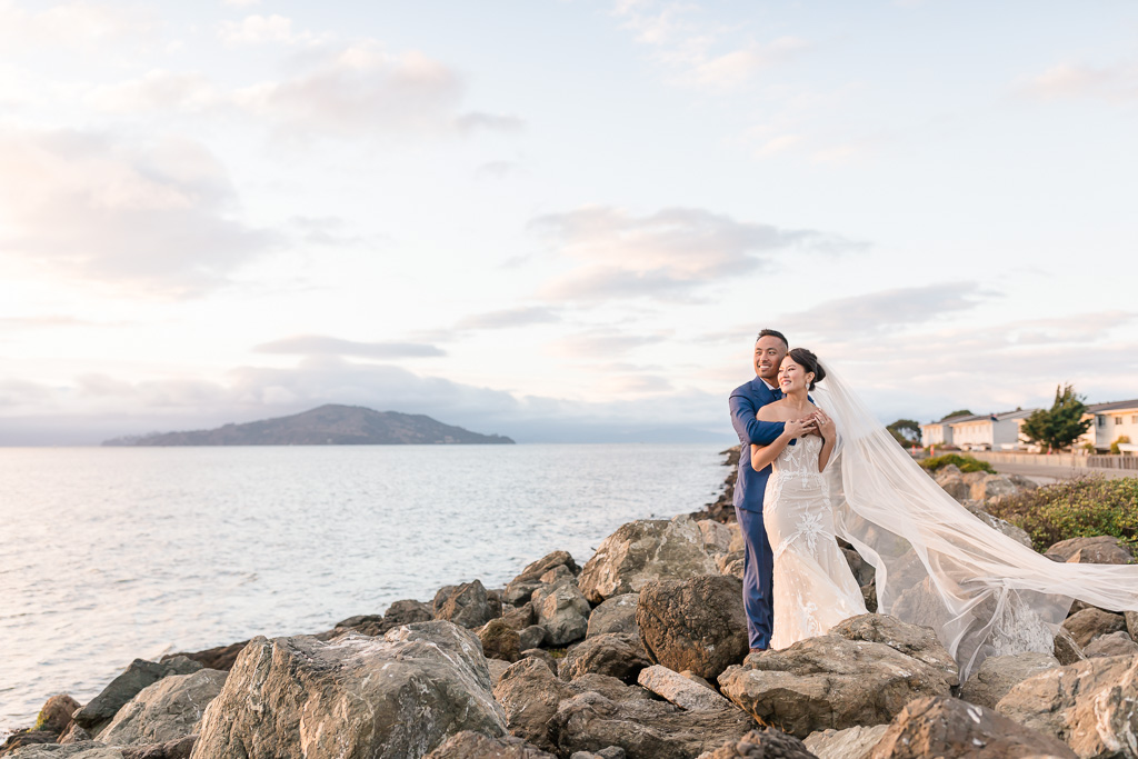 glowing Treasure Island sunset wedding photo on rocks by the Bay