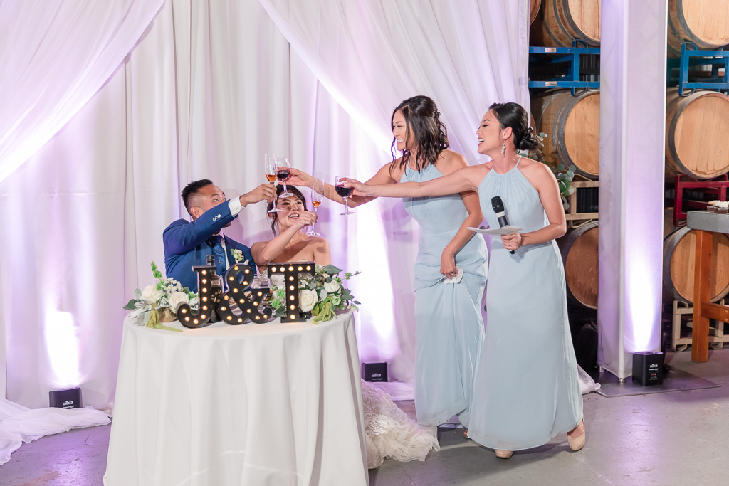 bridesmaids proposing a wine toast to the bride and groom