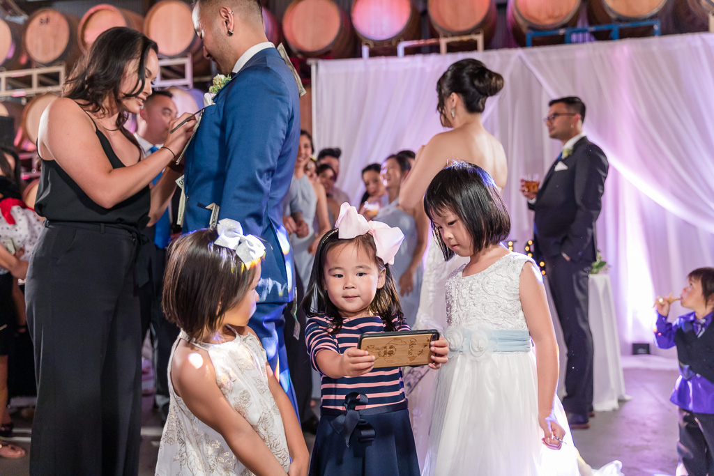 adorable little girls taking selfie at wedding