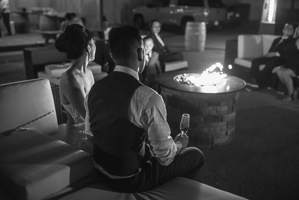 couple enjoying a quiet moment in front of fire pit at night
