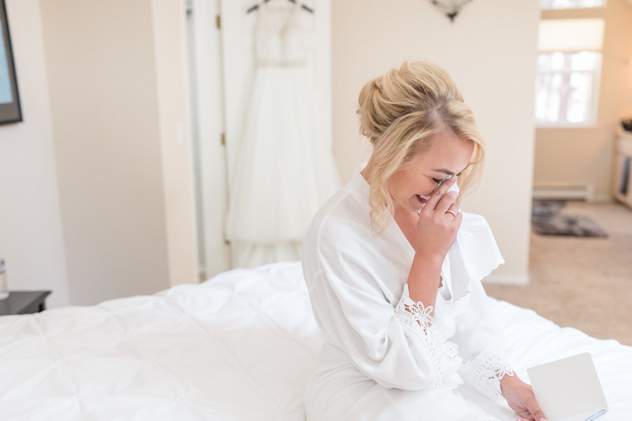 emotional moment of bride wiping away a tear on the morning of her wedding