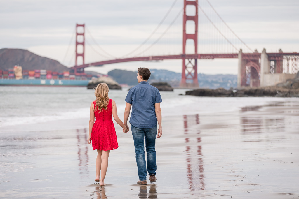 Golden Gate Bridge engagement photo with a colorful cargo ship in the background