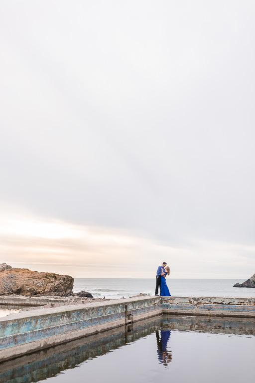 dancing by the water under the dramatic skies - San Francisco engagement photographer