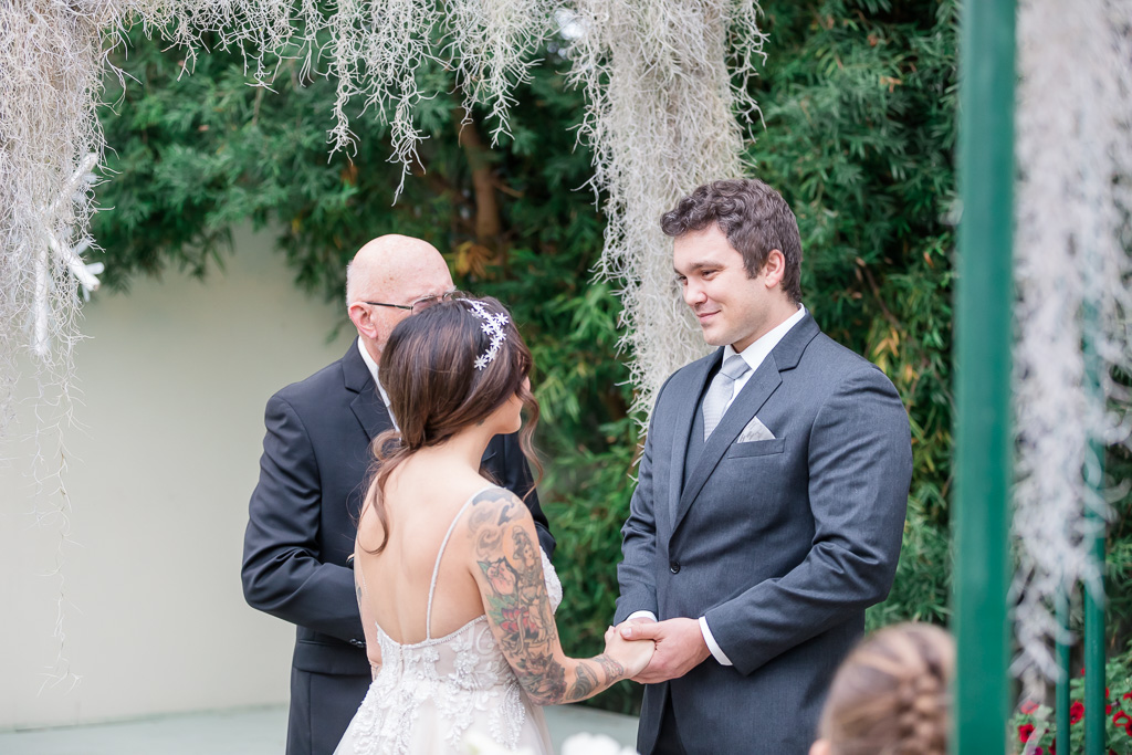 groom looking into bride’s eyes during wedding ceremony
