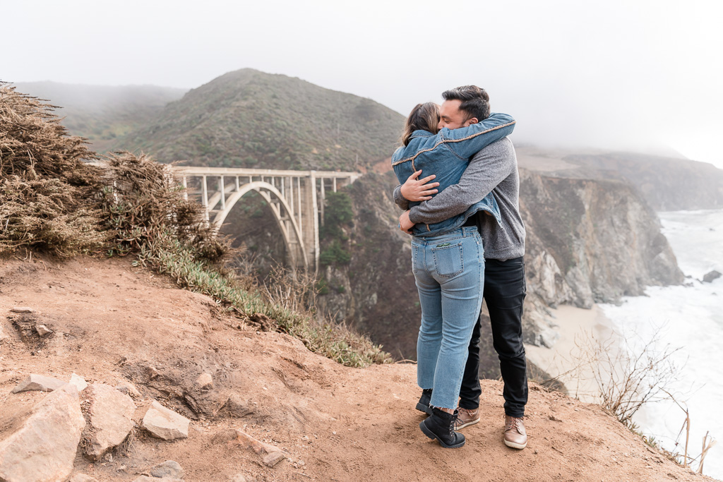 hugging after she said yes in front of the Bixby Bridge