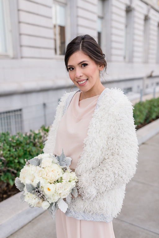gorgeous bride in her bridal shawl in front of SF city hall building