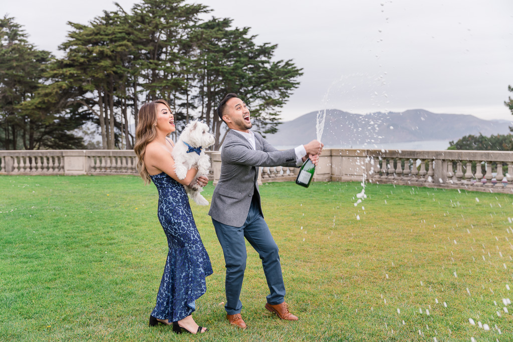 super fun champagne popping engagement photo at Lands End