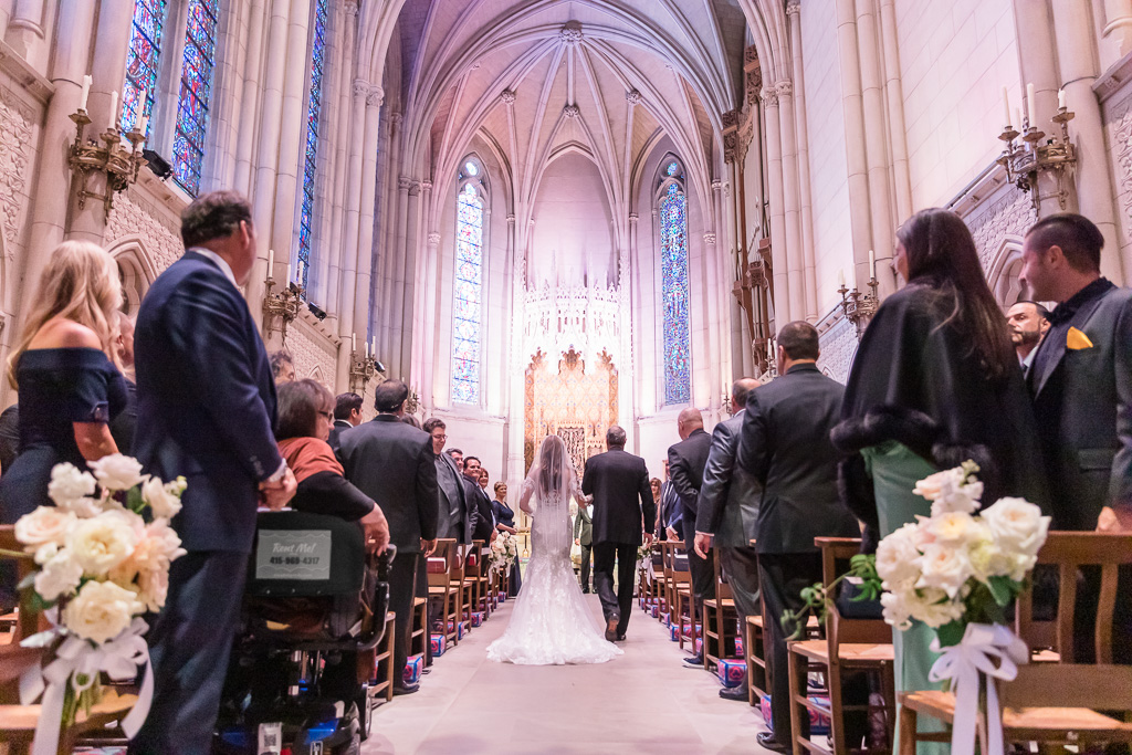 bride walks down the aisle at the Grace Cathedral