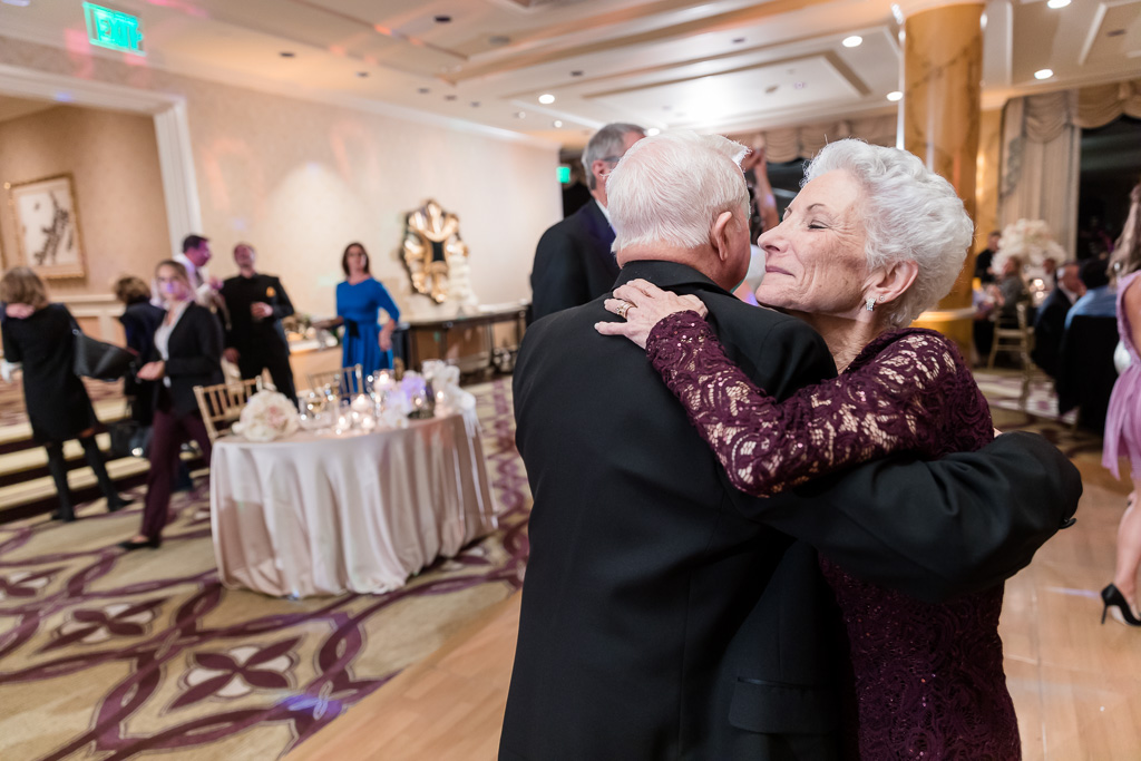 old couple snuggling each other on the dance floor