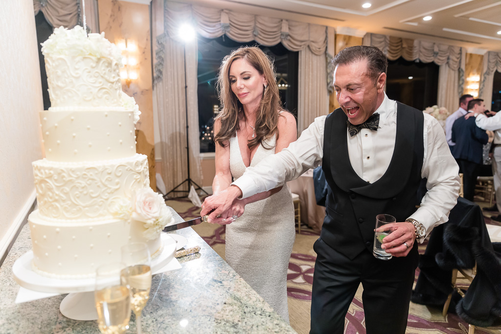 newlyweds cutting their wedding cake