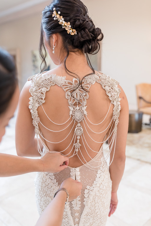 zipping up this delicate back of a designer gown