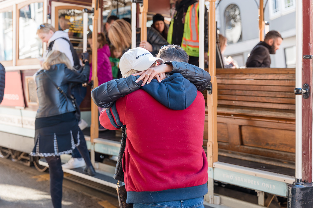 a big hug after they got engaged on the San Francisco trolley