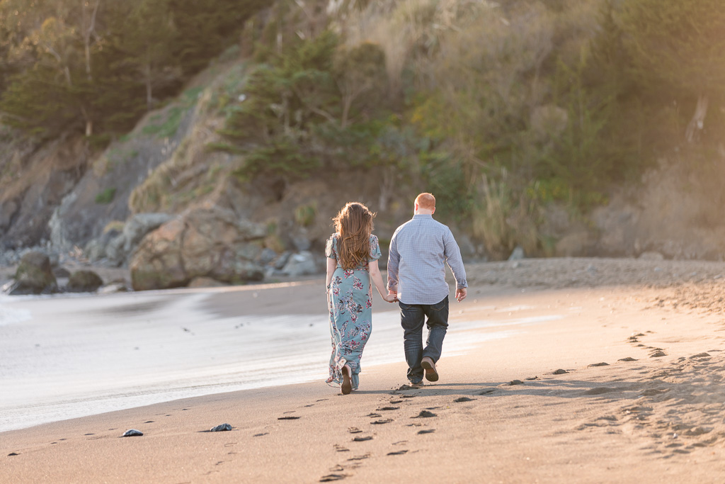 Muir Beach sunset engagement session couple walking alone the beach in the beautiful sunlight