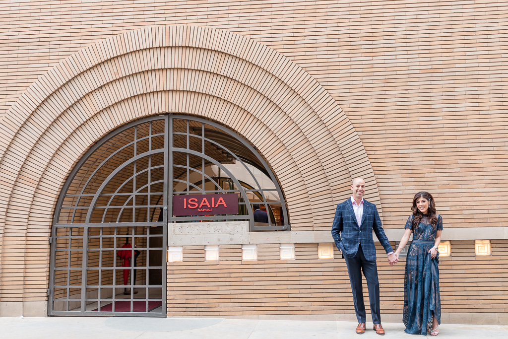 engagement photos at Maiden Lane ISAIA store next to spiral entrance