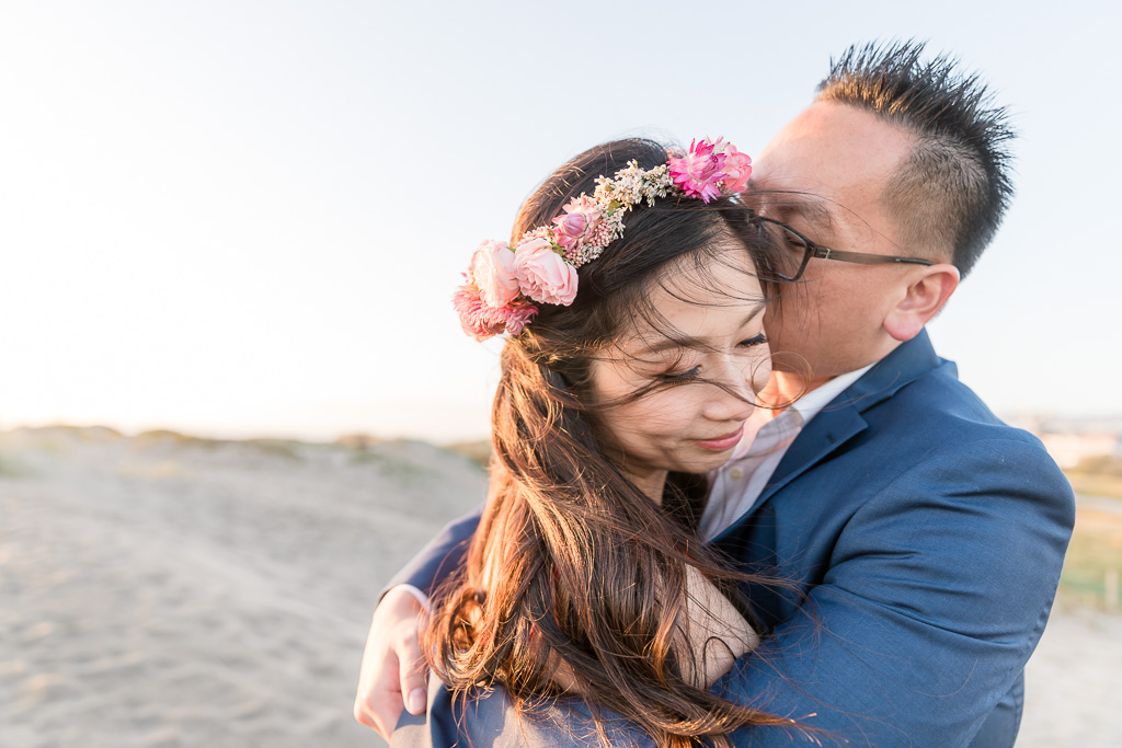 romantic San Francisco sunset engagement photo on the beach with a flower crown