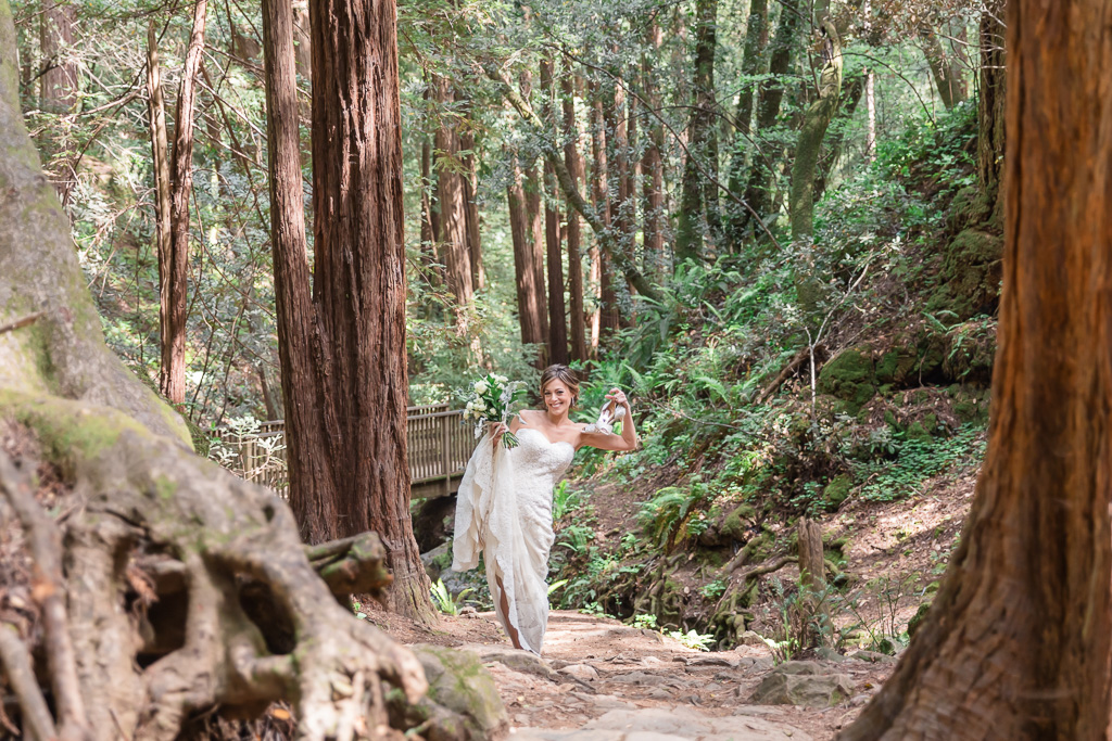 bride walking toward the first look spot in redwoods