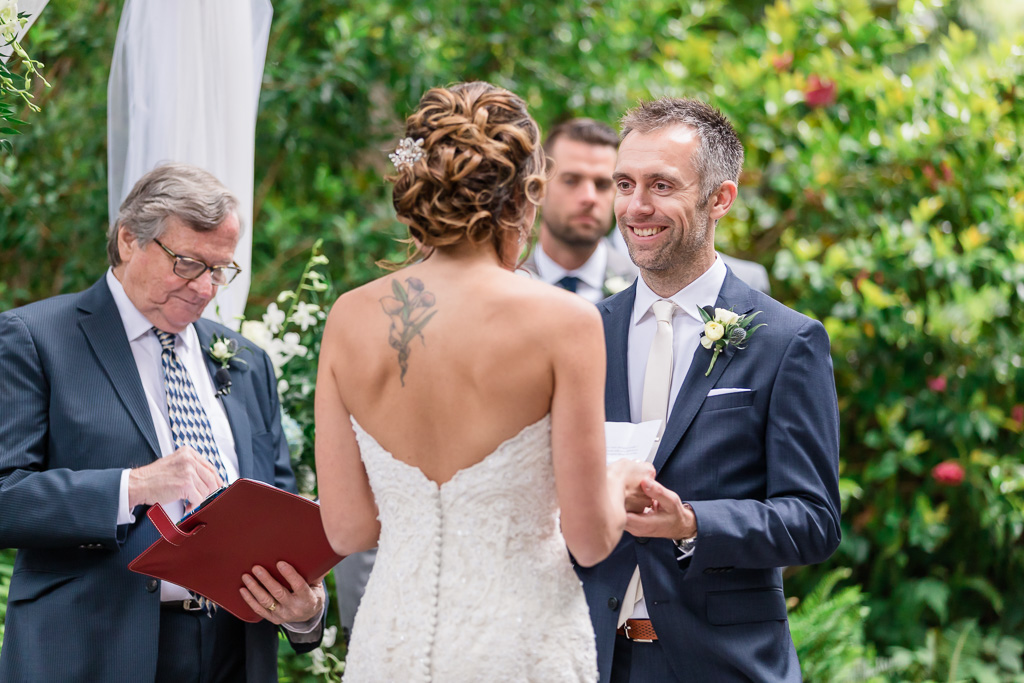 bride reading her vows and the look on groom's face is adorable
