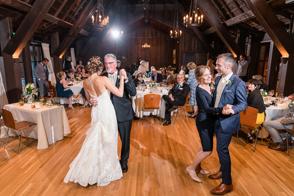 bride and groom dancing with their parents at the same time