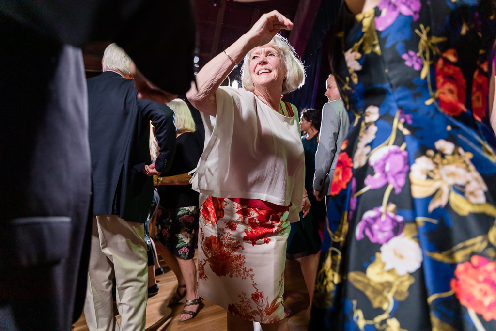 an older wedding guest having so much fun on the dance floor