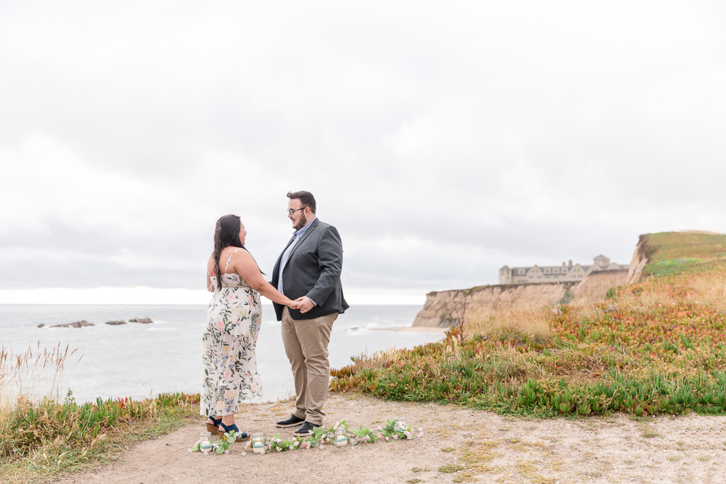 cute surprise proposal in Half Moon Bay on a secluded cliff