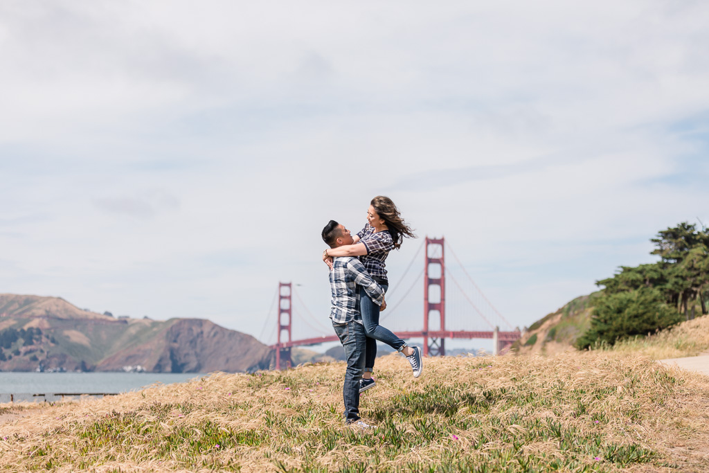 playful engagement picture in front of the golden gate bridge