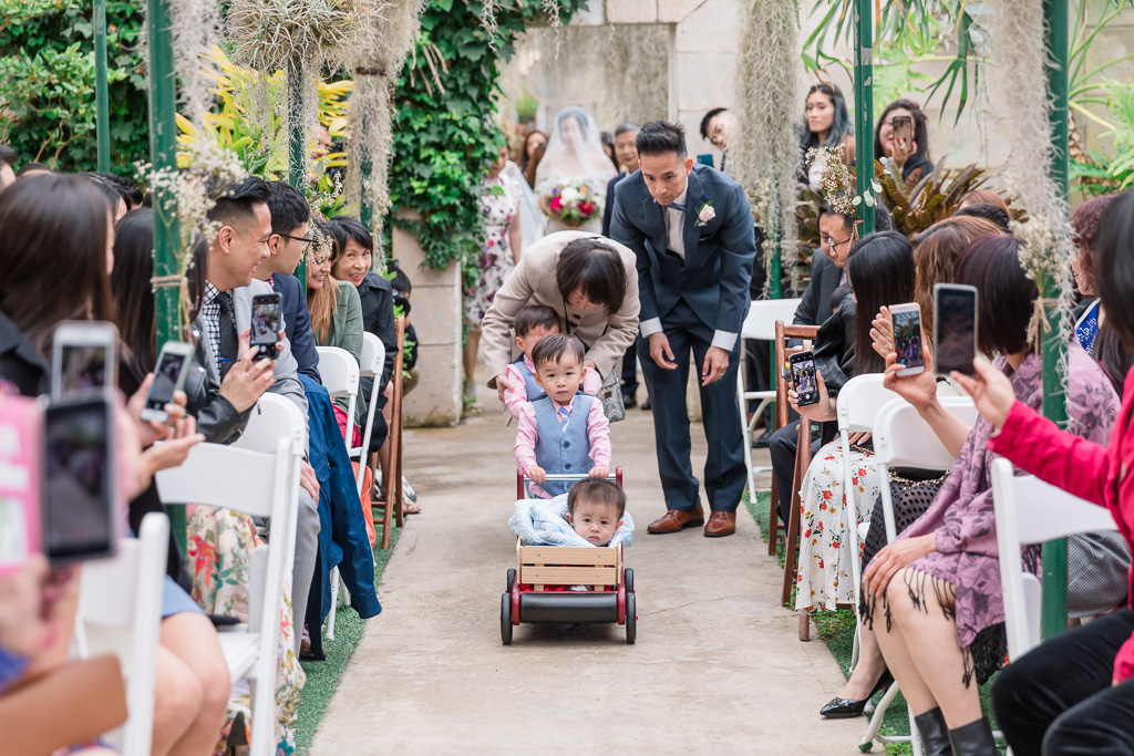 tiny ring bearer in his wagon