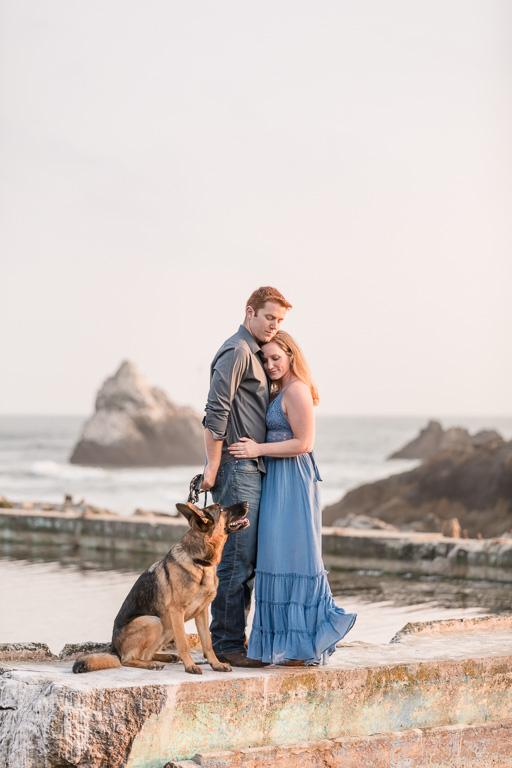 sweet engagement photo with cute dog by the water