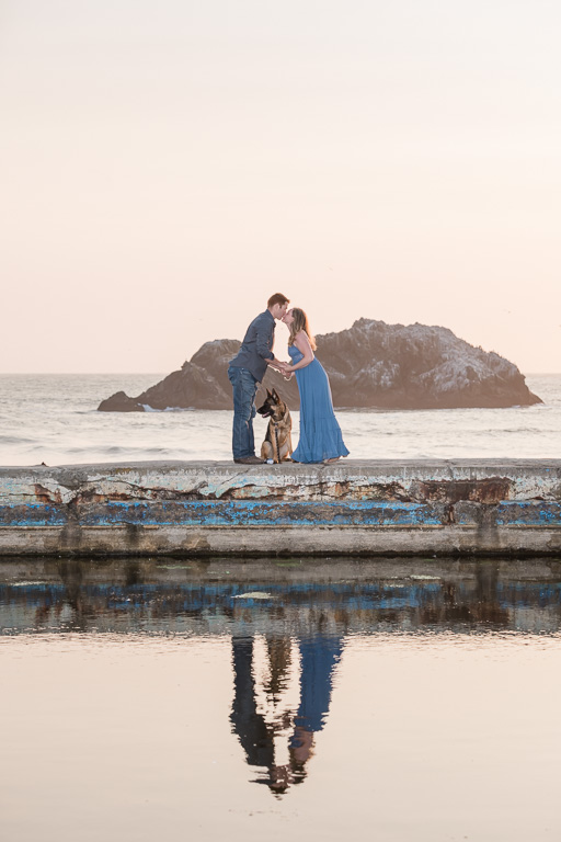 kissing engagement photo with dog in San Francisco by the water