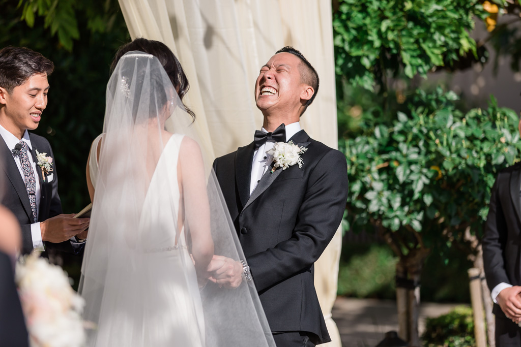 groom laughing during the ceremony