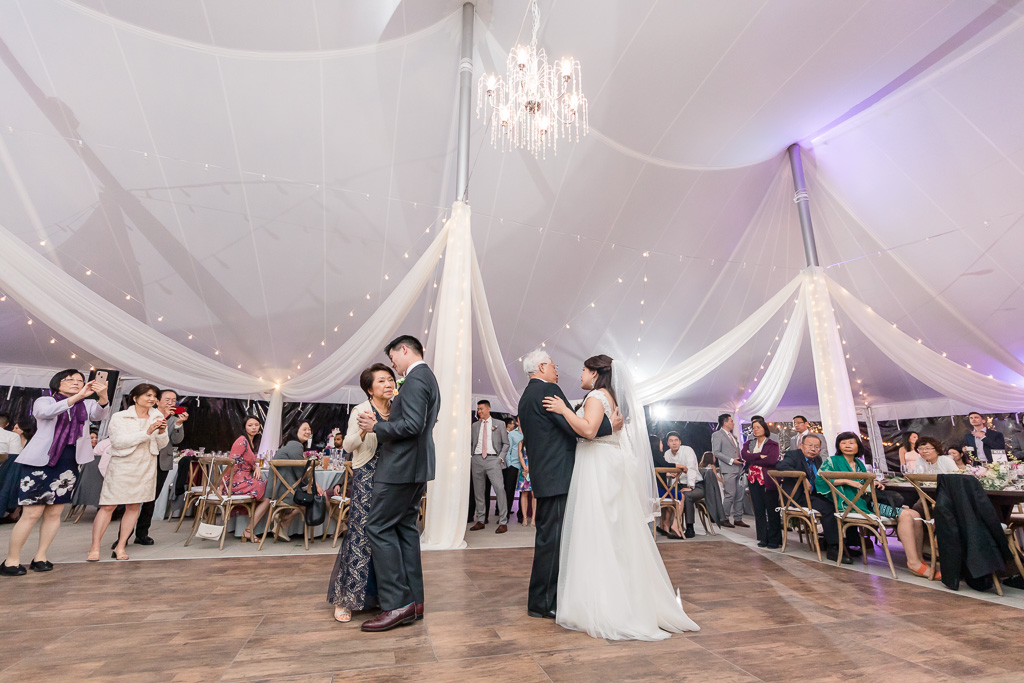 bride and groom dancing with their parents at the same time