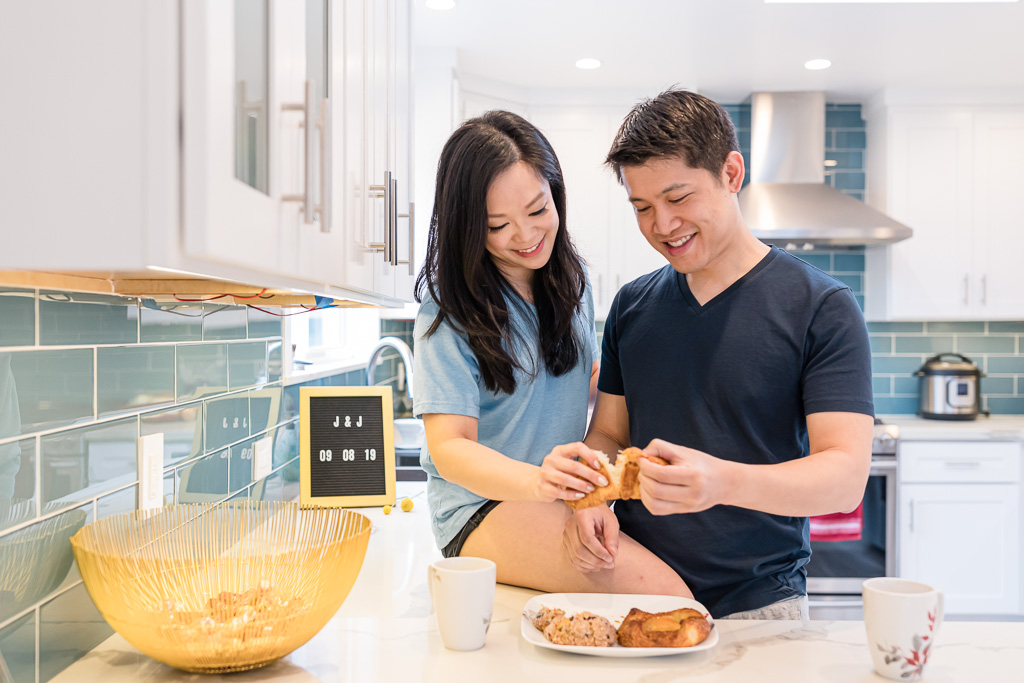 couple enjoying pastries together at home for their engagement session