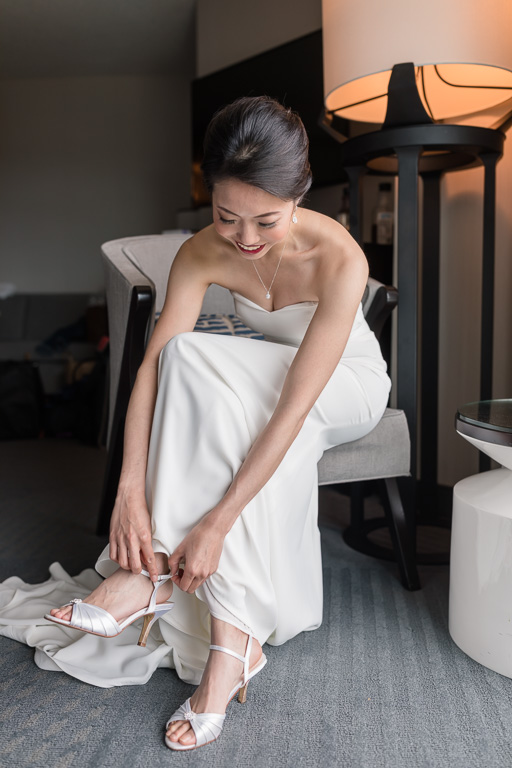 bride putting the shoes on her