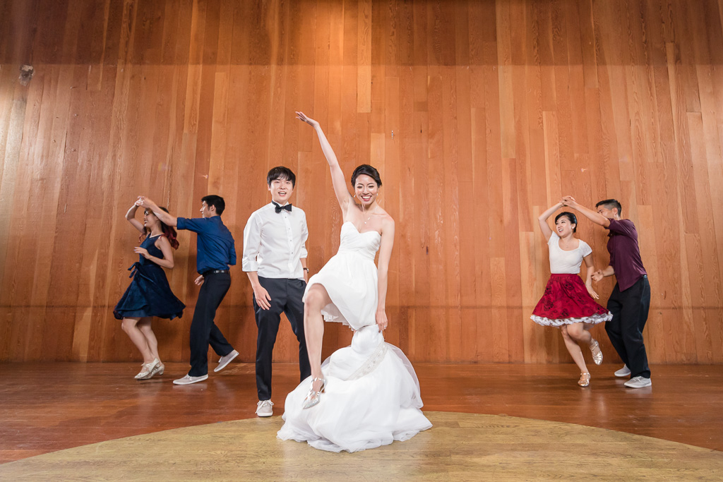 bride and groom surprised their guests by a group swing dance