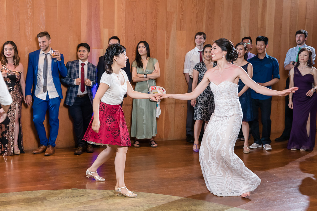 bride swing dancing with her bridesmaid
