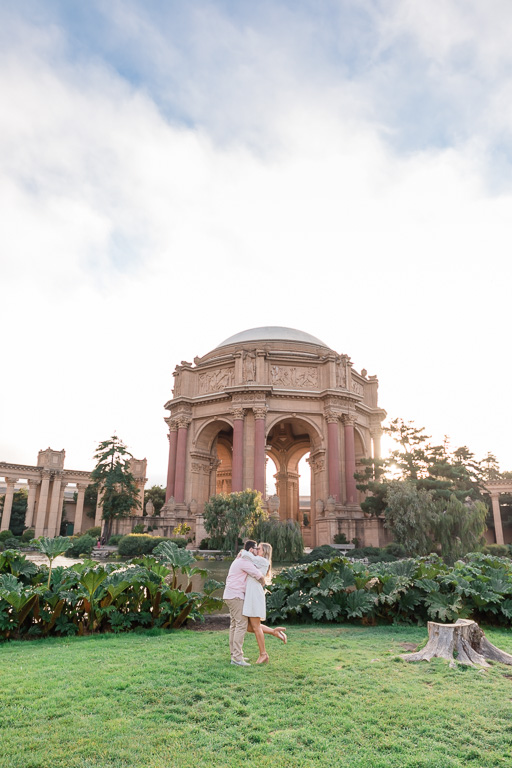 kissing in front of the pond across the Palace of Fine Arts dome