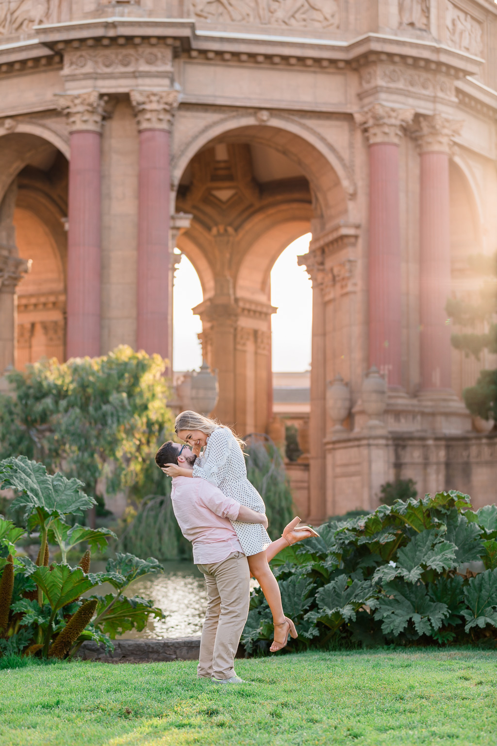 beautiful engagement photo at Palace of Fine Arts under the golden sunlight