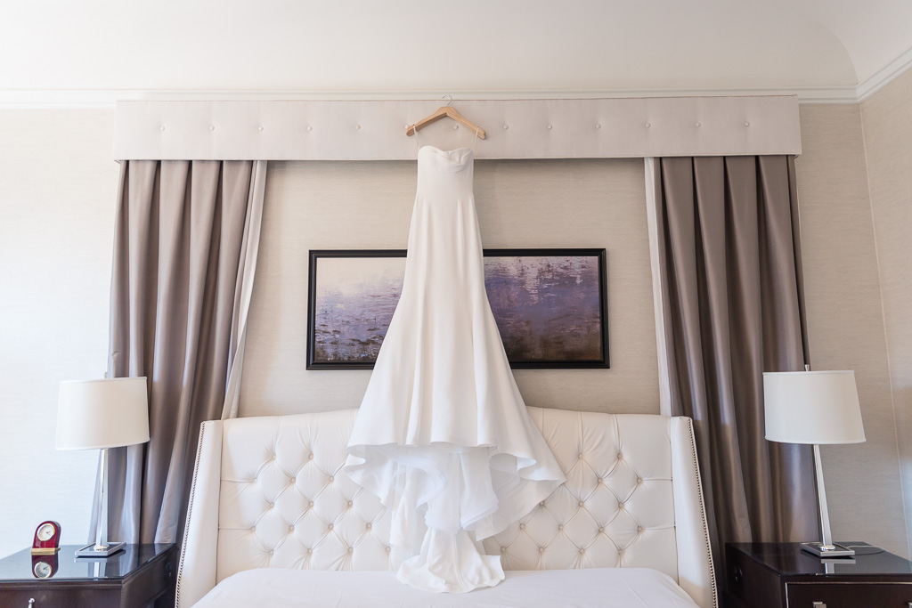 elegant wedding gown hanging in the SF Fairmont suite