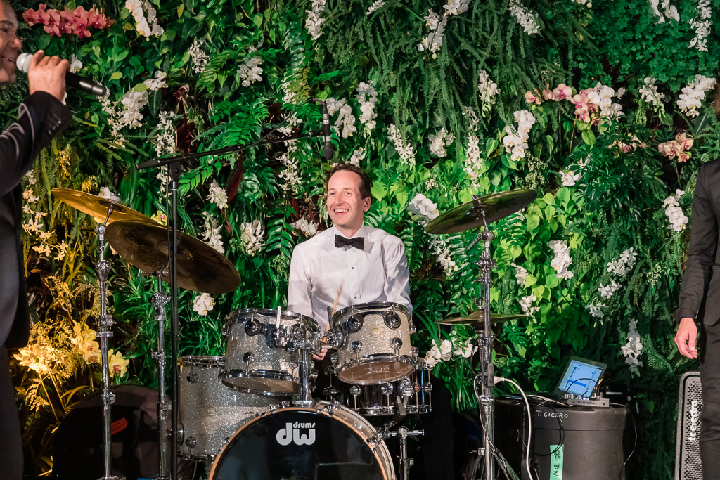 groom plays the drums at his own wedding reception party