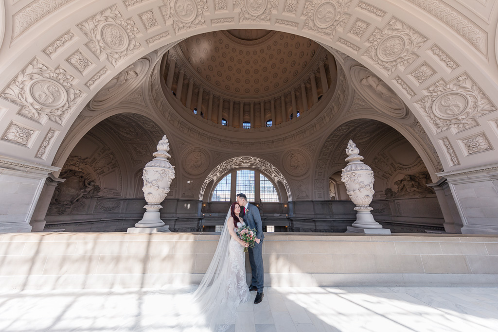 dramatic city hall wedding photo under the archway