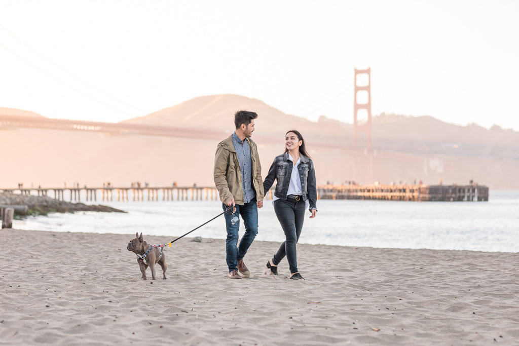 engaged couple walking at Crissy Field with their puppy