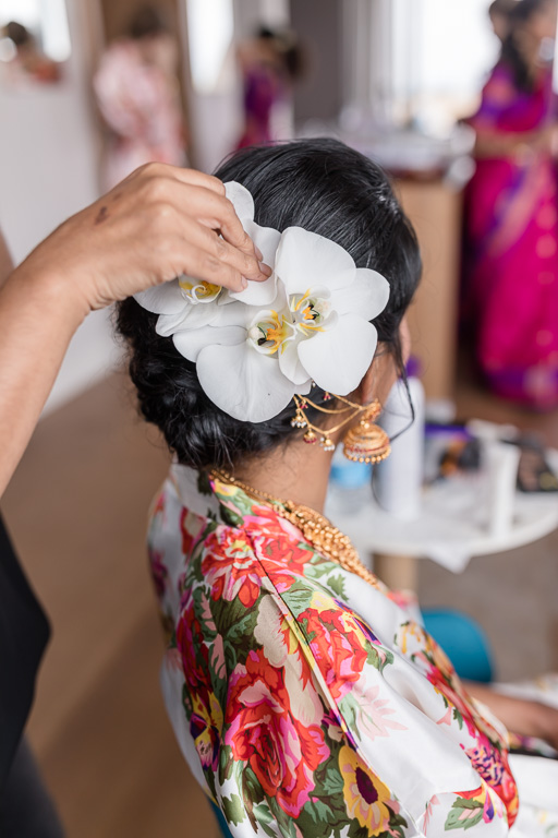 fresh white orchid as a part of the bridal hair piece