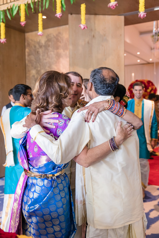 parents hugging each other after the ceremony