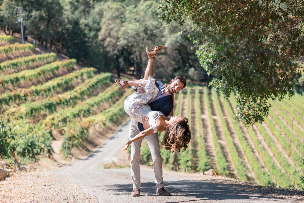 playful and lively engagement photo in front of vineyards