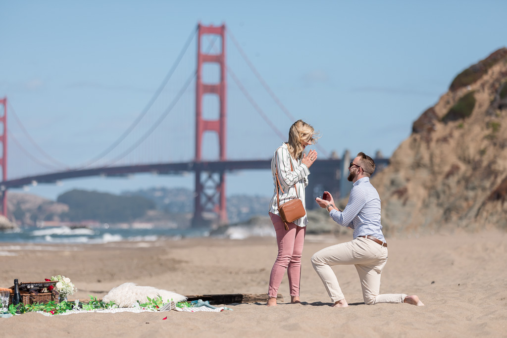 San Francisco baker beach surprise proposal with a picnic setup