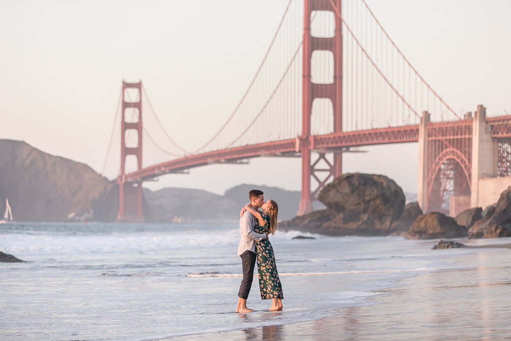 San Francisco beach engagement photo in front of Golden Gate Bridge