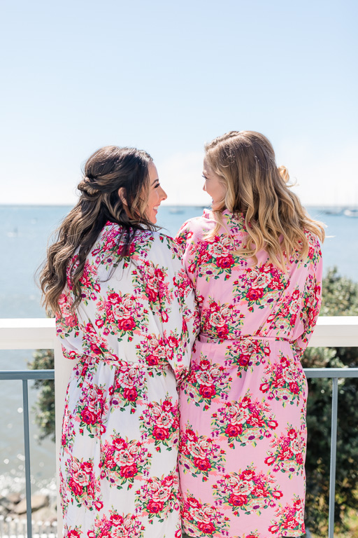 bride chilling with her bridesmaid in their floral robe
